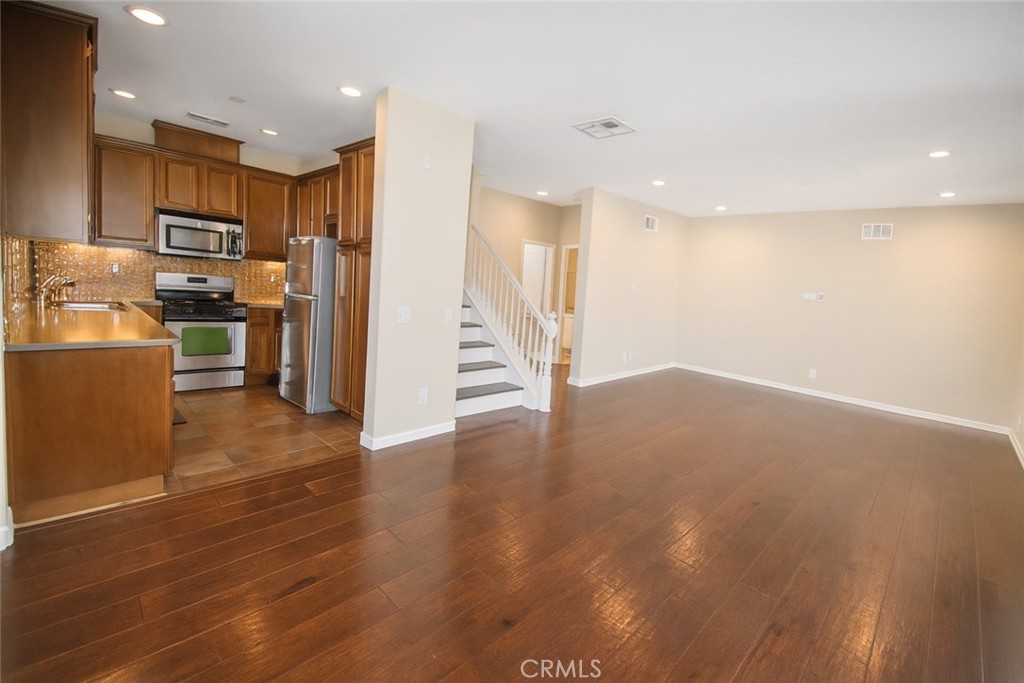 8045 Torino Stanton, CA 90680 - Photo 11 of 21 a view of a kitchen with wooden floor