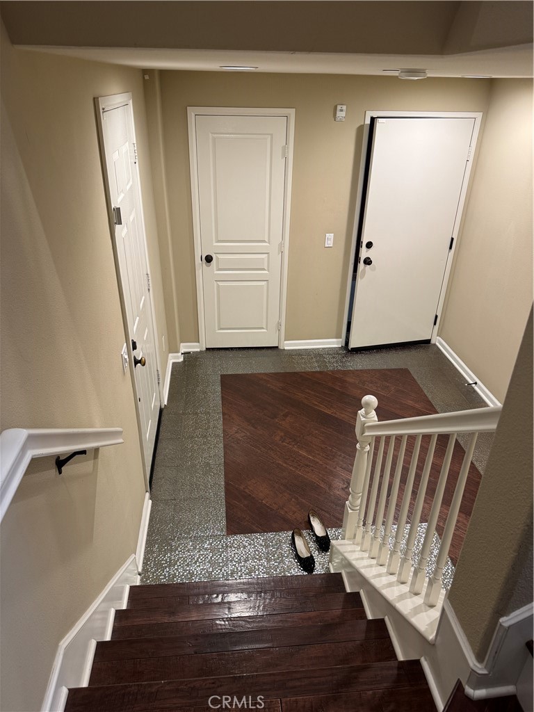 8045 Torino Stanton, CA 90680 - Photo 14 of 21 a view of a hallway with wooden floor and staircase