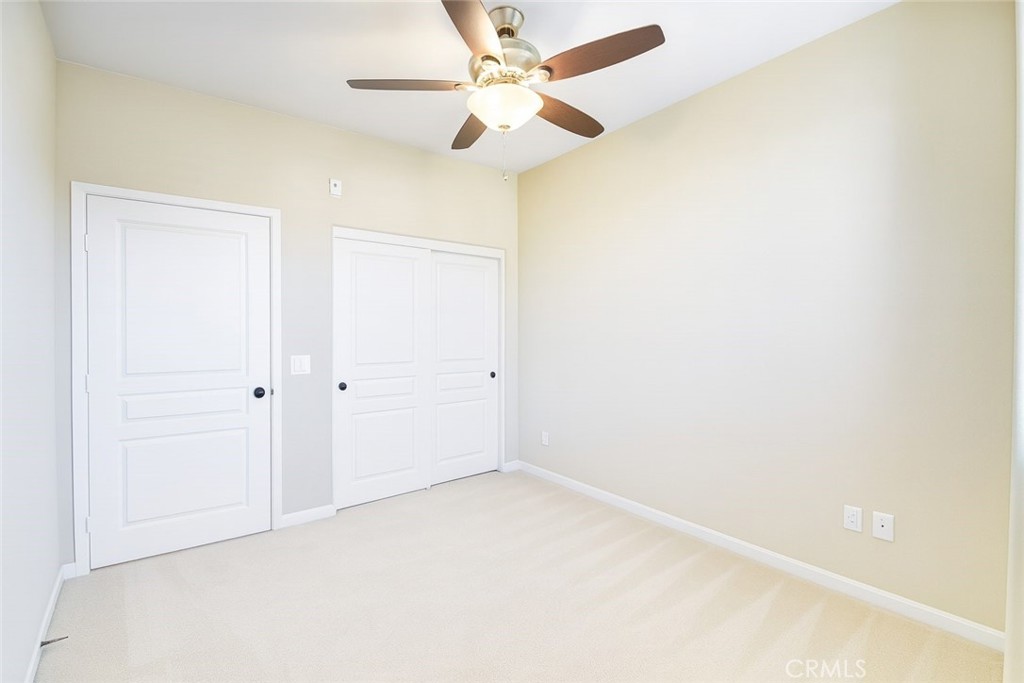 8045 Torino Stanton, CA 90680 - Photo 16 of 21 an empty room with a ceiling fan and a window