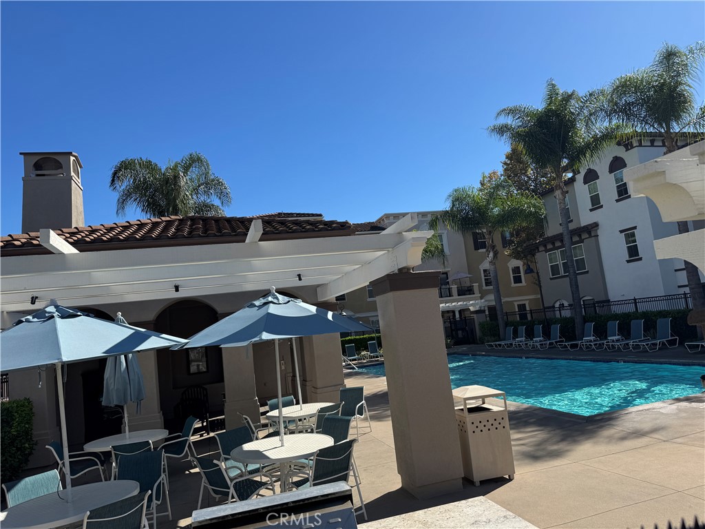 8045 Torino Stanton, CA 90680 - Photo 4 of 21 a view of a patio with table and chairs a barbeque