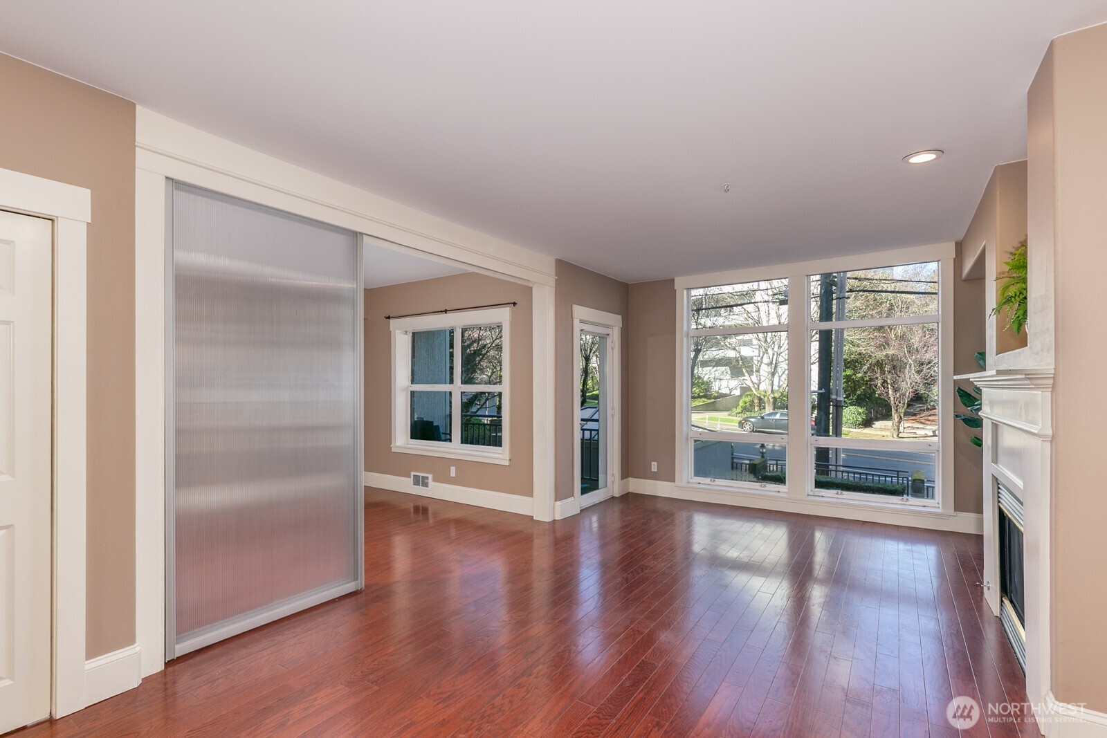 3221 Southwest Avalon Way, Unit 201 Seattle, WA 98126 - Photo 12 of 39 an empty room with wooden floor and windows