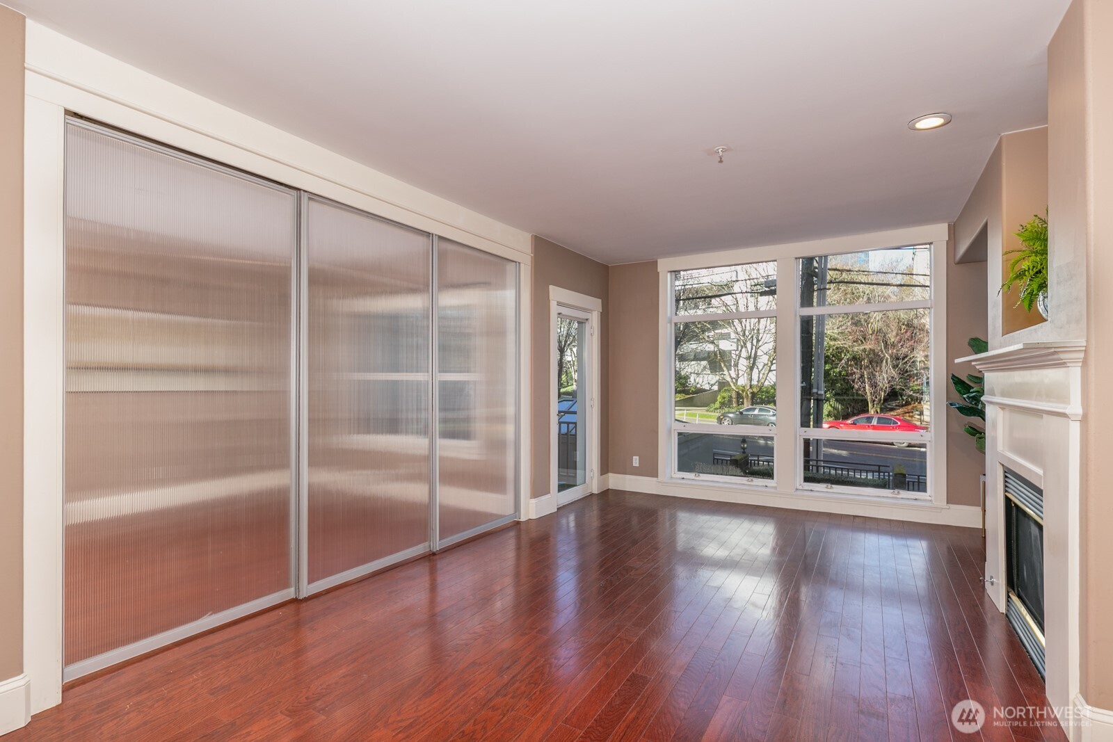 3221 Southwest Avalon Way, Unit 201 Seattle, WA 98126 - Photo 13 of 39 a view of an empty room with wooden floor and a window