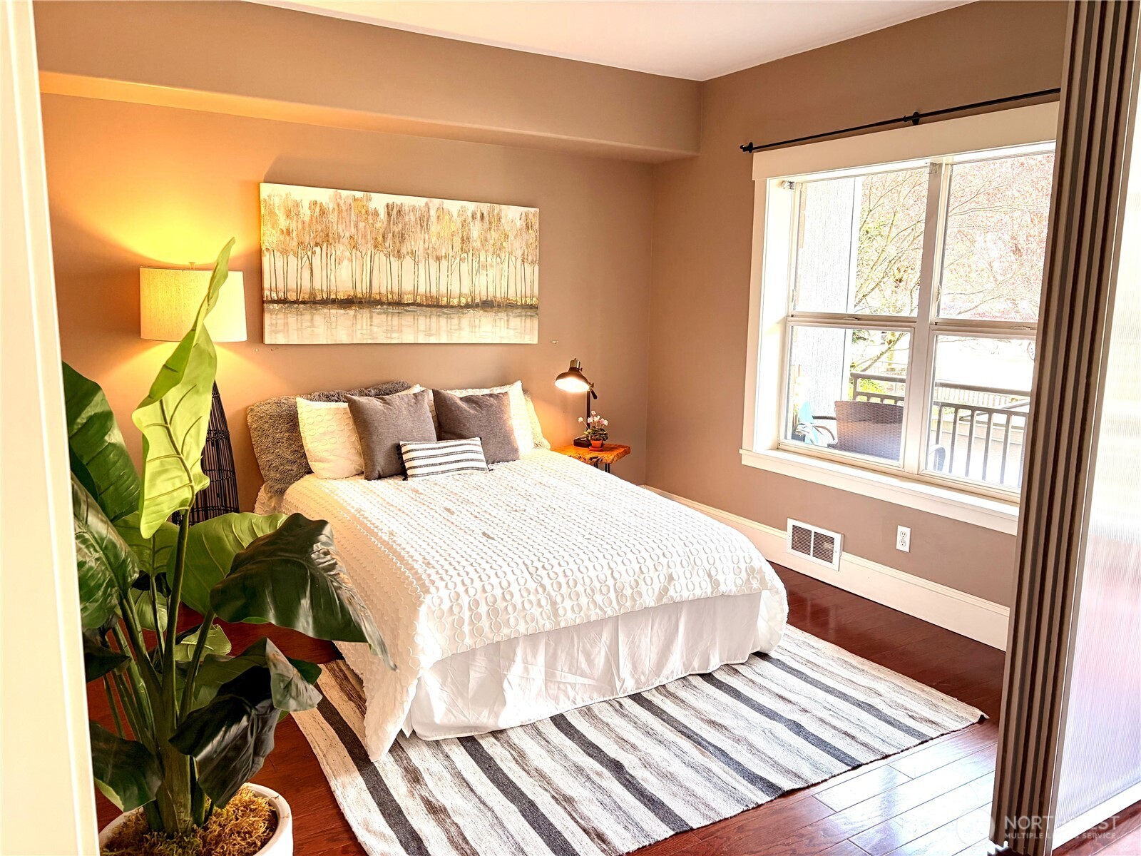 3221 Southwest Avalon Way, Unit 201 Seattle, WA 98126 - Photo 15 of 39 a bedroom with a bed and a window