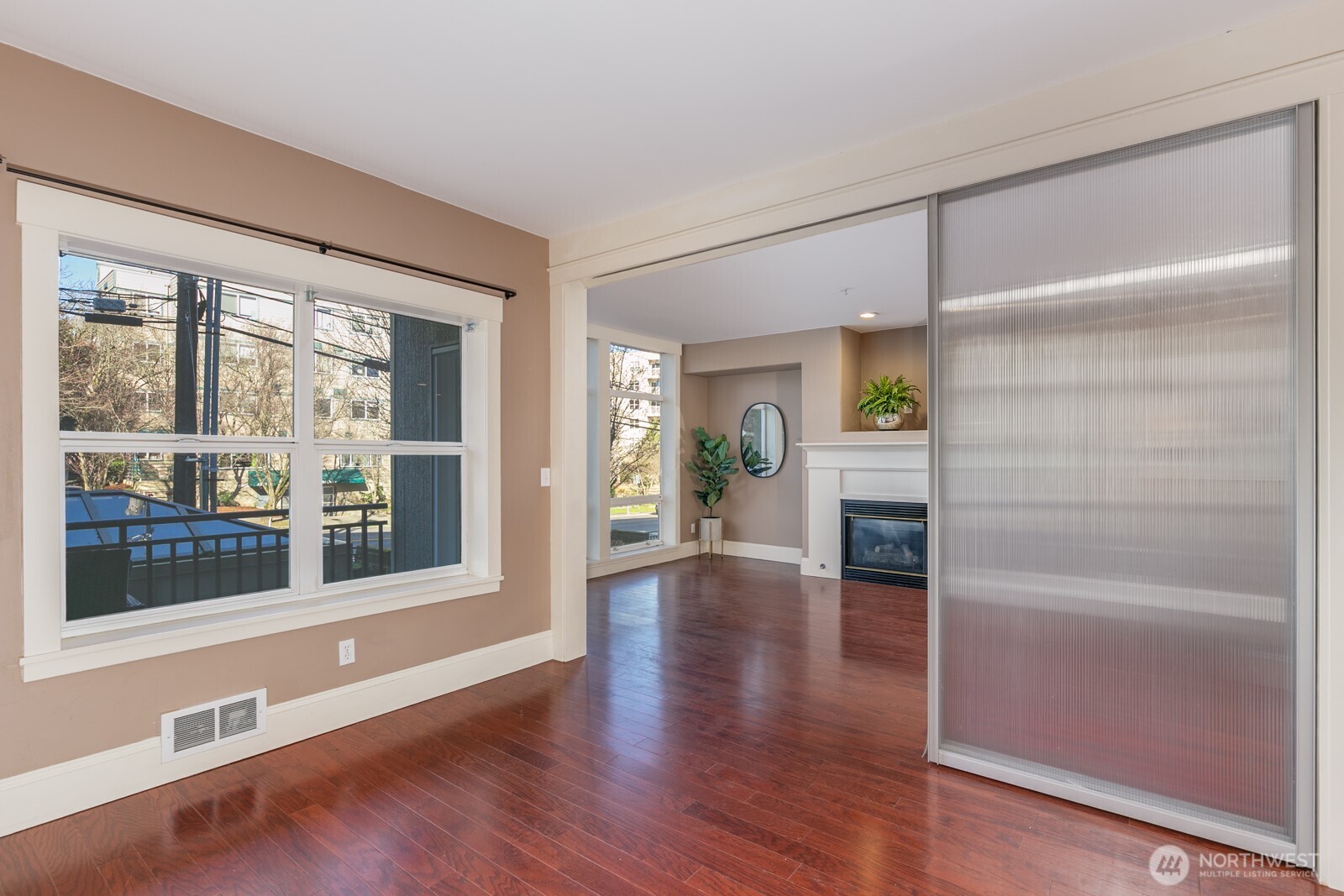 3221 Southwest Avalon Way, Unit 201 Seattle, WA 98126 - Photo 16 of 39 a hallway with wooden floor fireplace and windows