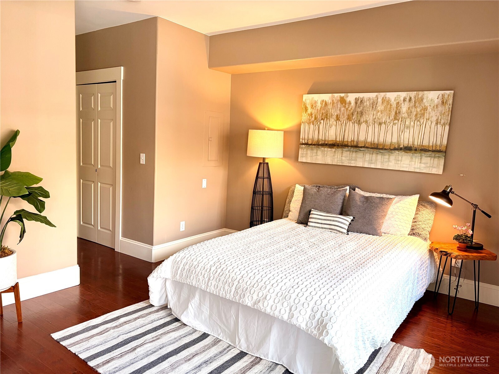 3221 Southwest Avalon Way, Unit 201 Seattle, WA 98126 - Photo 18 of 39 a bedroom with a bed and wooden floor
