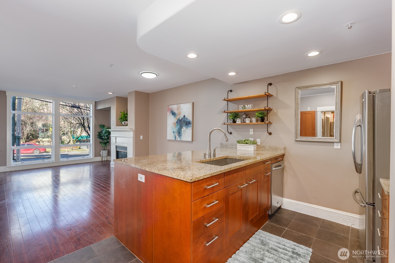 3221 Southwest Avalon Way, Unit 201 Seattle, WA 98126 - Photo 2 of 39 a kitchen with stainless steel appliances granite countertop a sink stove and wooden floor