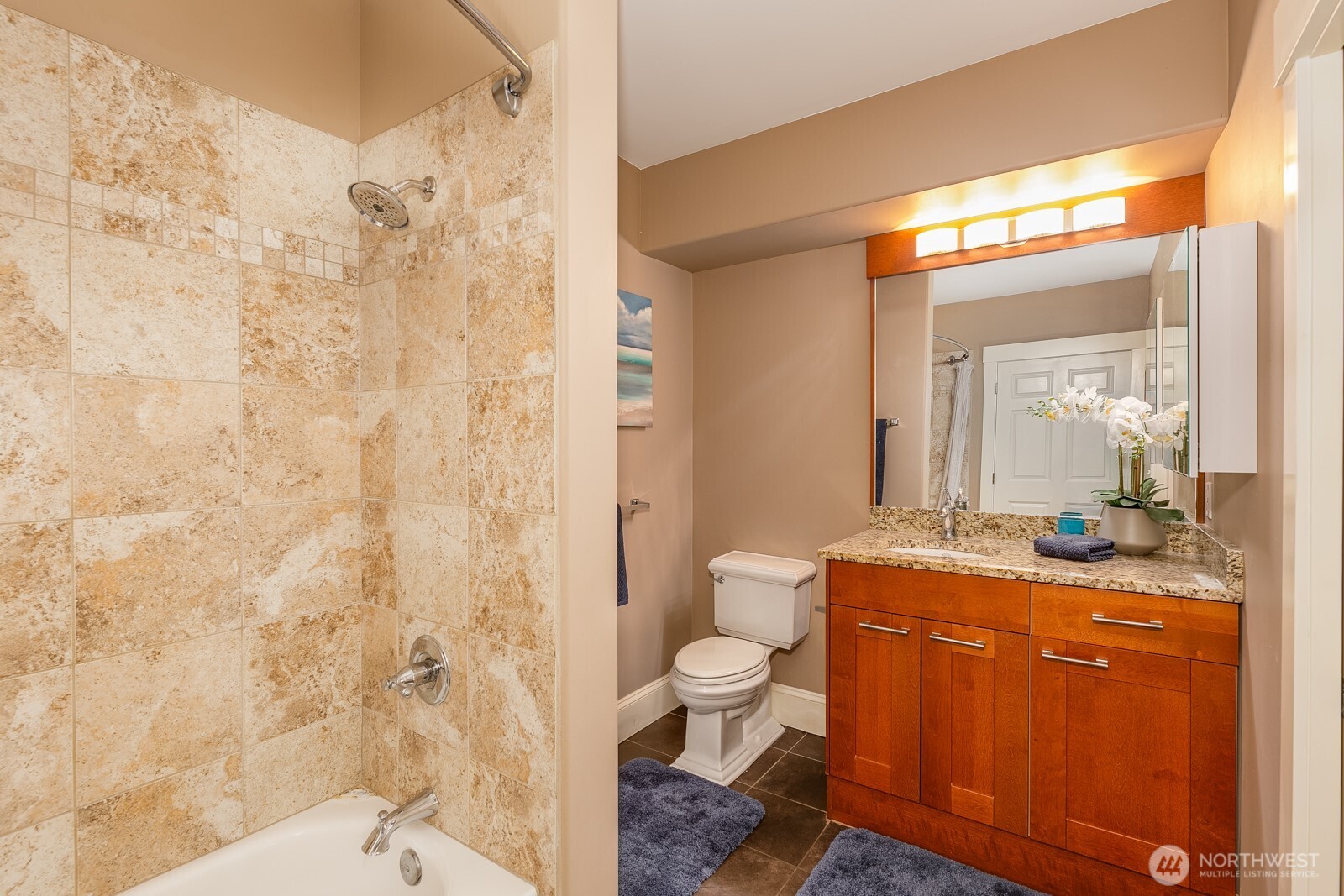 3221 Southwest Avalon Way, Unit 201 Seattle, WA 98126 - Photo 25 of 39 a bathroom with a granite countertop sink toilet a mirror and shower