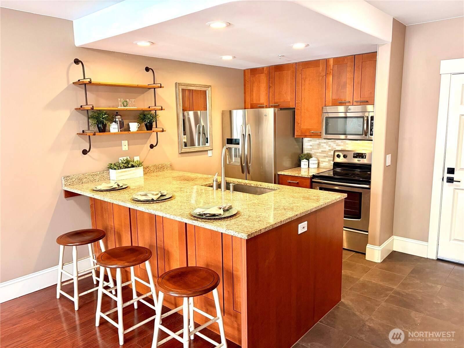 3221 Southwest Avalon Way, Unit 201 Seattle, WA 98126 - Photo 4 of 39 a kitchen with stainless steel appliances kitchen island granite countertop a sink and cabinets