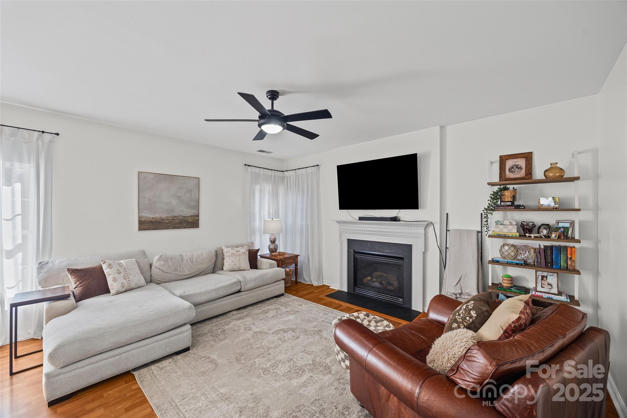 543 St George Road Fort Mill, SC 29708 - Photo 8 of 42 a living room with furniture a fireplace and a flat screen tv