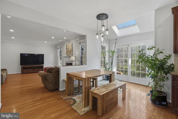 a living room with furniture a flat screen tv and a floor to ceiling window