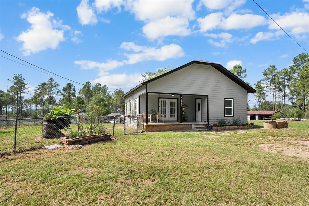 a view of a house with a yard and sitting area