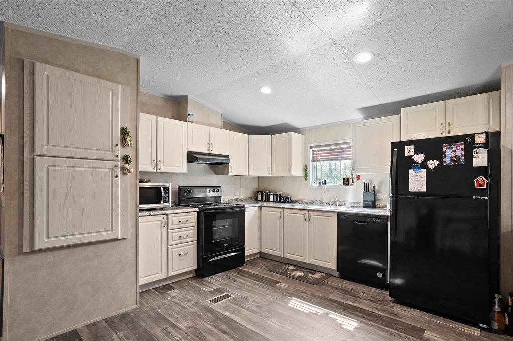 6446 Farm To Market Road 752 Rusk, TX 75785 - Photo 17 of 40 a kitchen with stainless steel appliances granite countertop a refrigerator stove top oven and sink