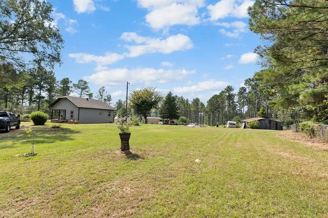 a house view with swimming pool in front of the house