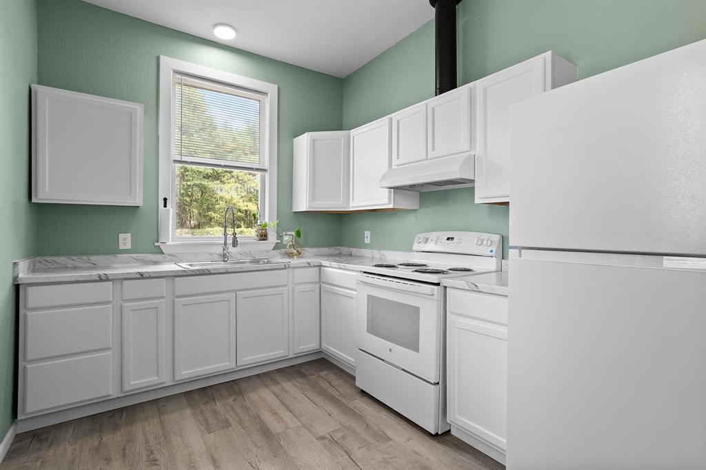 6446 Farm To Market Road 752 Rusk, TX 75785 - Photo 3 of 40 a kitchen with granite countertop white cabinets sink and white appliances