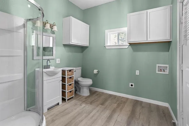 a bathroom with a toilet sink and mirror