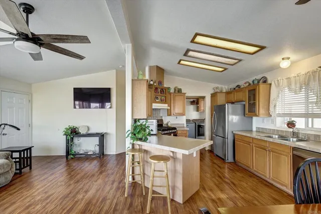a kitchen with a table chairs refrigerator and cabinets