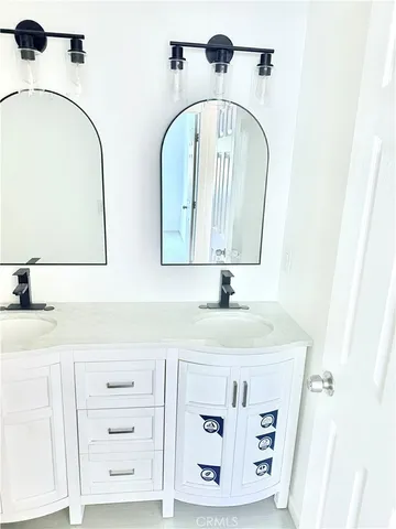 a white toilet sitting next to a bathroom sink
