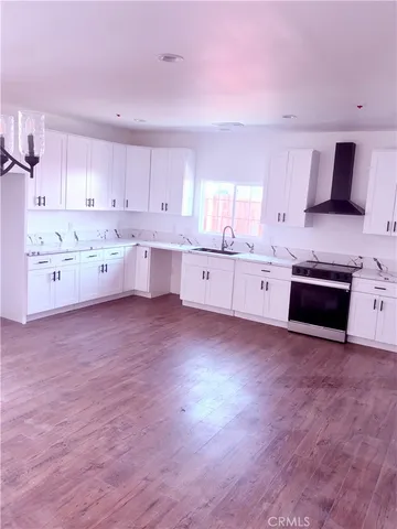 a view of a kitchen with furniture and a floor to ceiling window