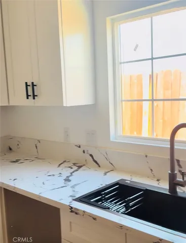 a view of a room with wooden floor and ceiling fan