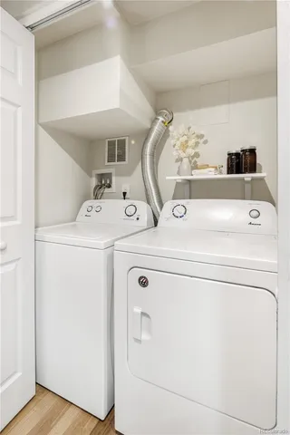 a backyard of a house with wooden fence and large trees