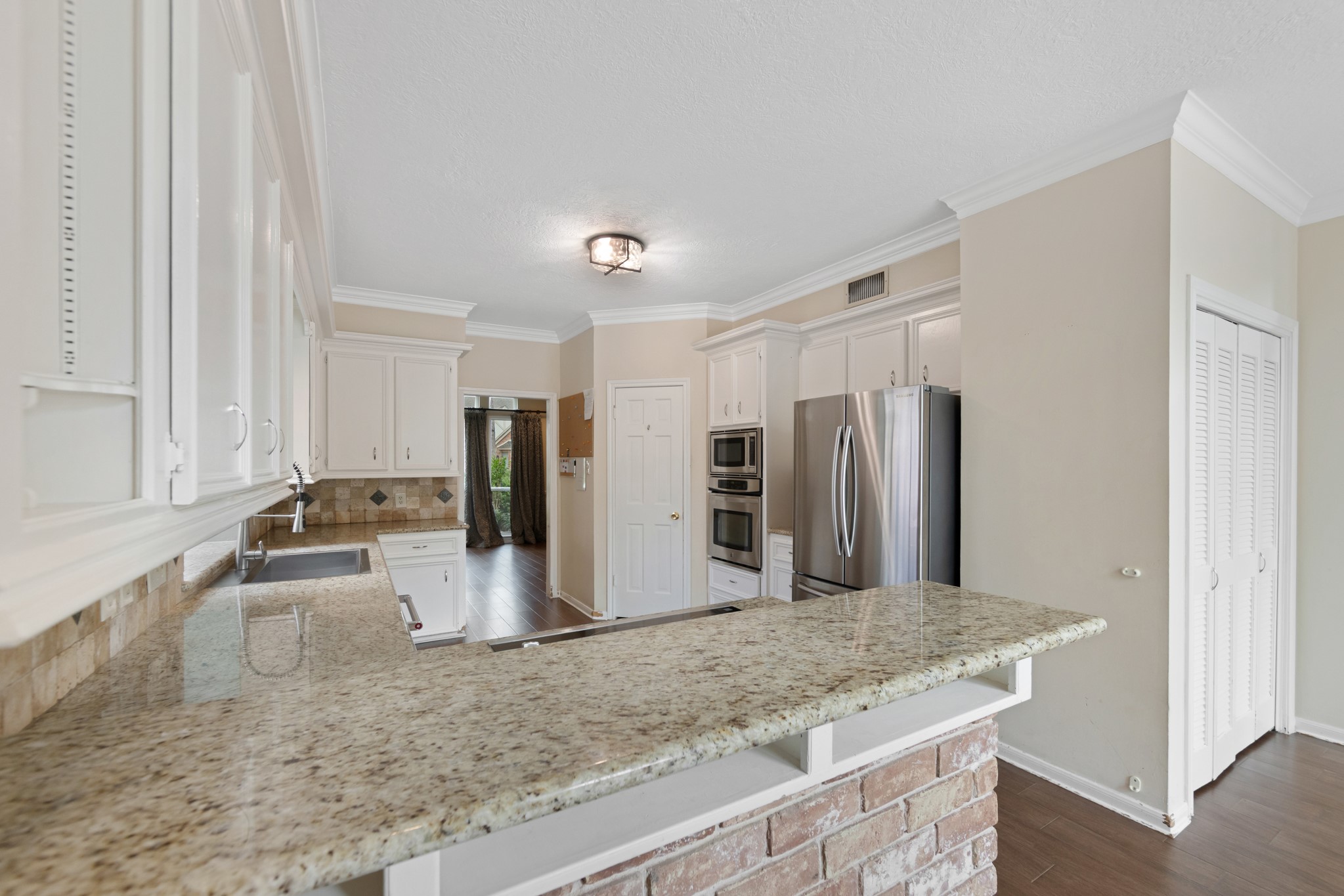 5115 Westerham Place Houston, TX 77069 - Photo 11 of 50 a kitchen with stainless steel appliances granite countertop a sink refrigerator and cabinets