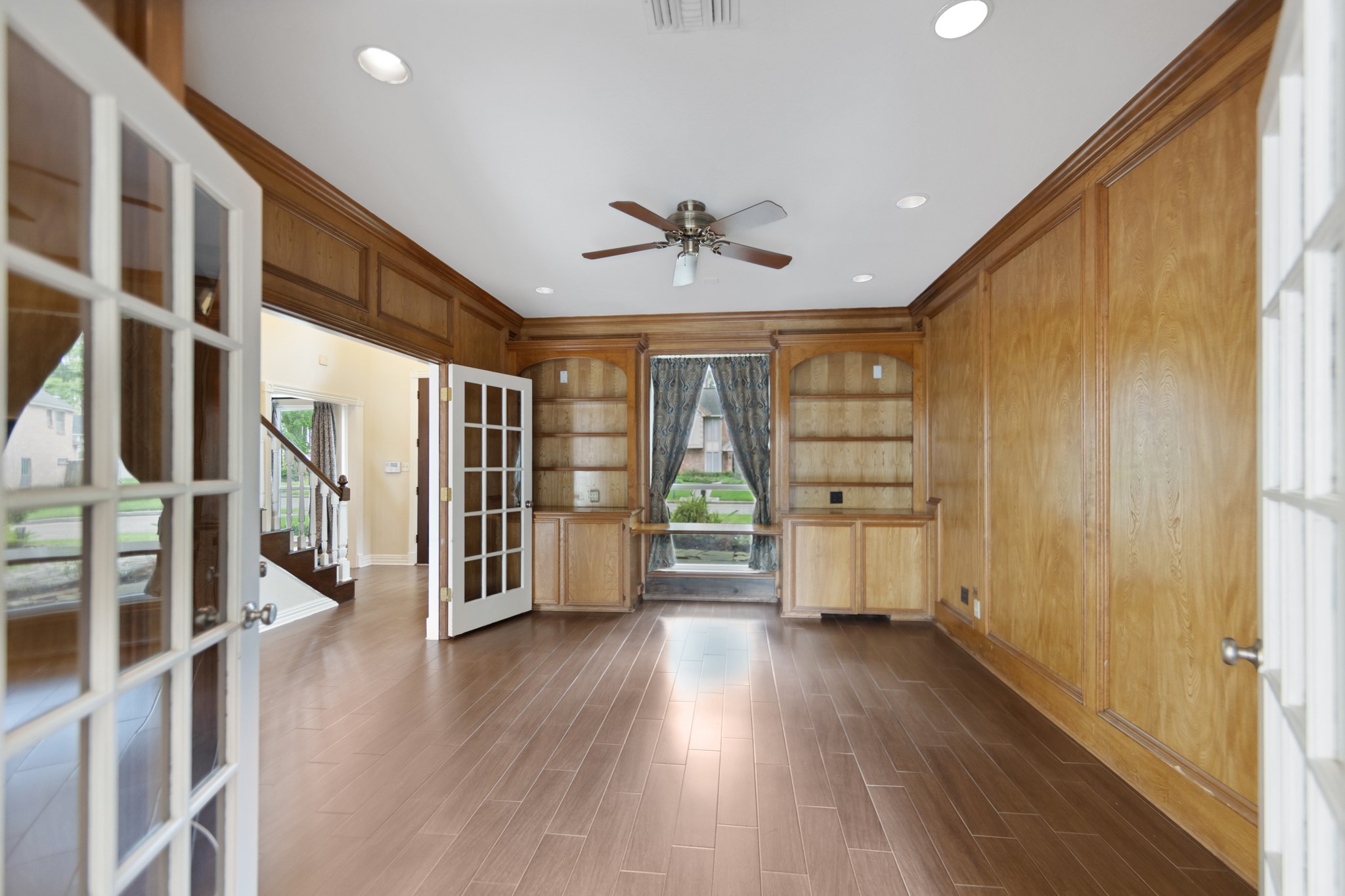 5115 Westerham Place Houston, TX 77069 - Photo 26 of 50 a view of an empty room with a window and wooden floor
