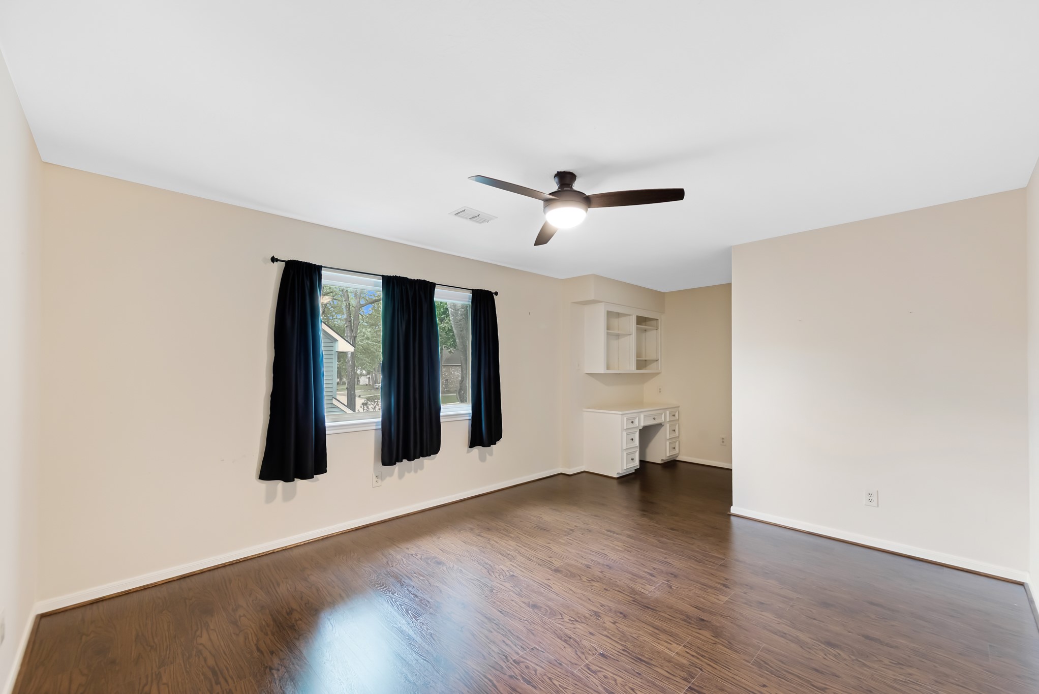 5115 Westerham Place Houston, TX 77069 - Photo 33 of 50 a view of an empty room with wooden floor and a window