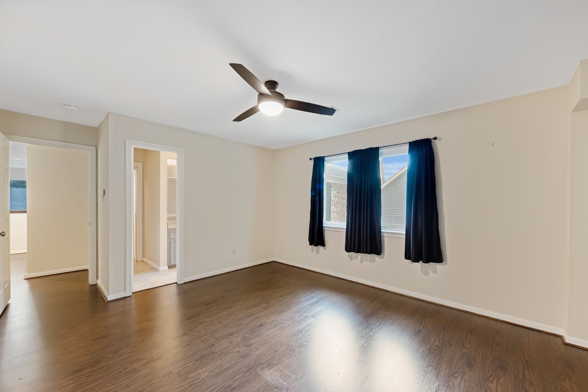 5115 Westerham Place Houston, TX 77069 - Photo 34 of 50 a view of an empty room with wooden floor and a window