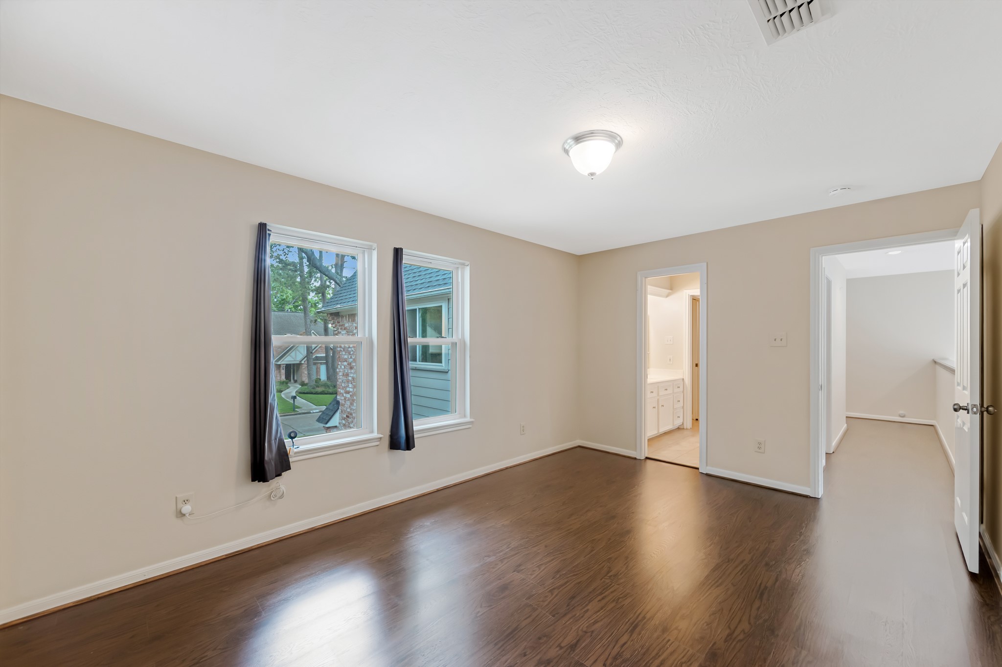5115 Westerham Place Houston, TX 77069 - Photo 37 of 50 an empty room with wooden floor and windows