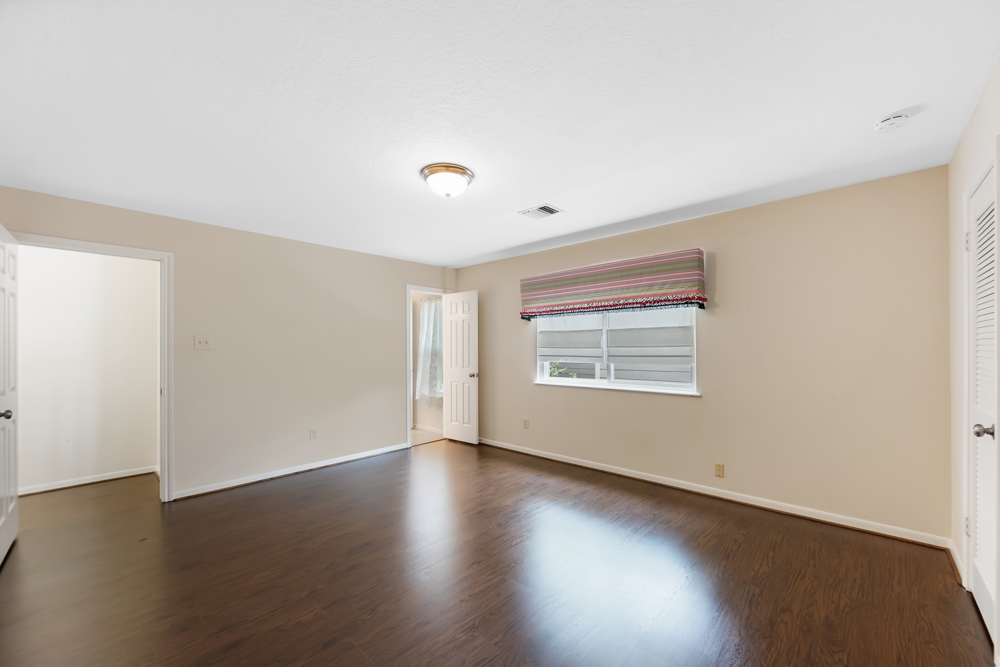 5115 Westerham Place Houston, TX 77069 - Photo 43 of 50 a view of an empty room with wooden floor and a window