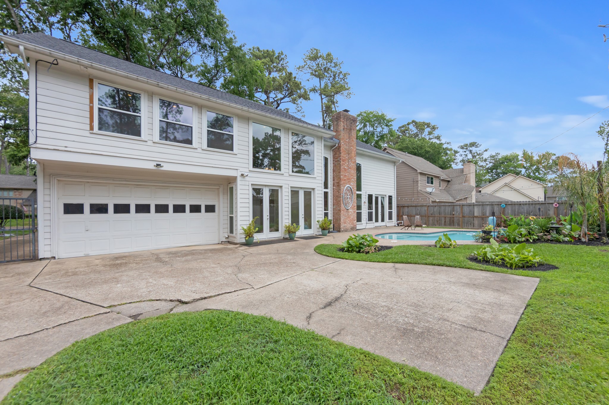 5115 Westerham Place Houston, TX 77069 - Photo 47 of 50 a view of a house with a yard and potted plants