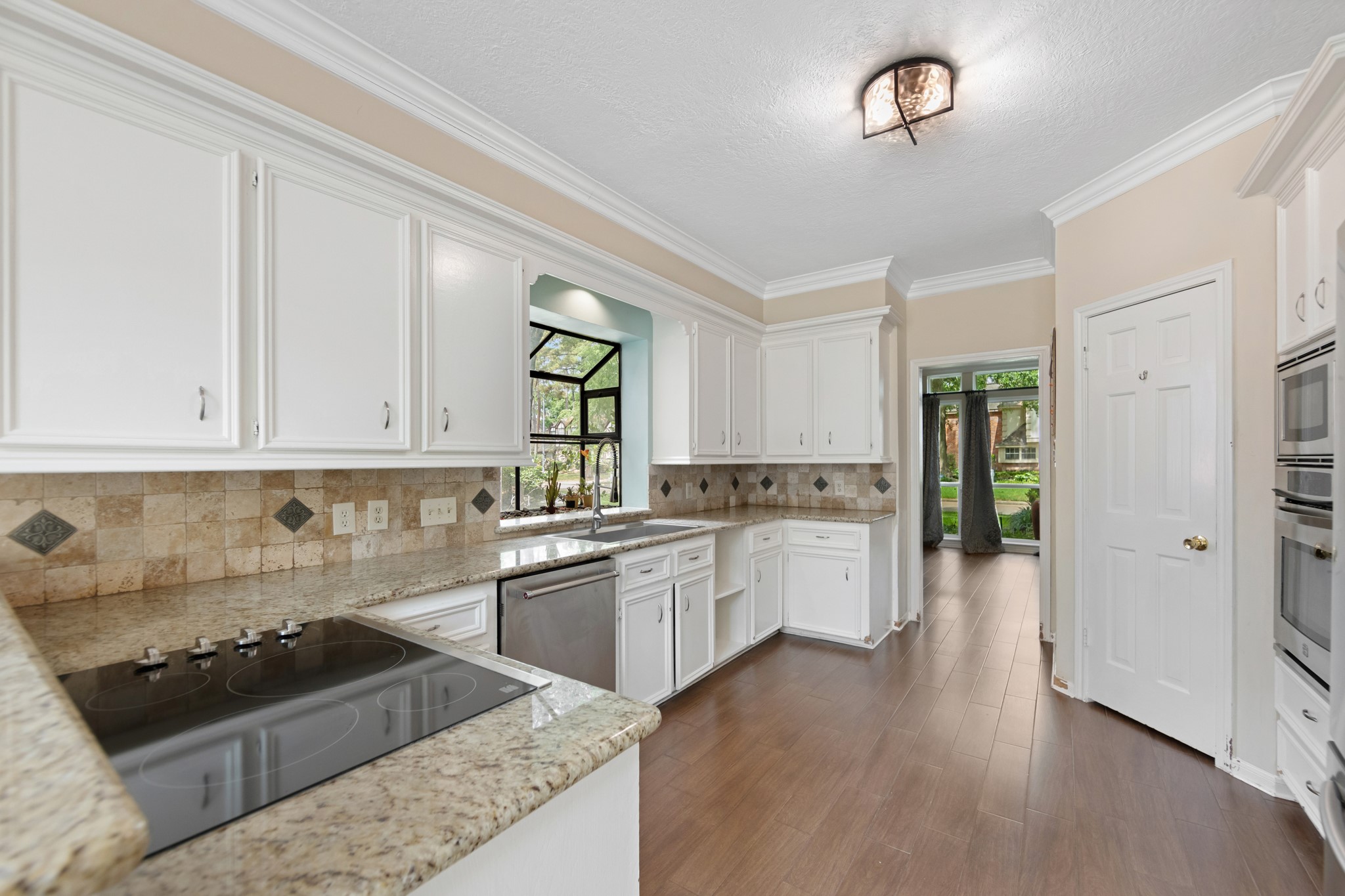 5115 Westerham Place Houston, TX 77069 - Photo 9 of 50 a kitchen with granite countertop a stove a sink dishwasher and a refrigerator