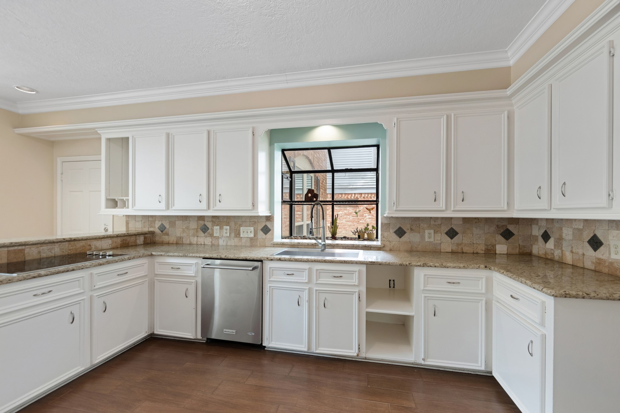 5115 Westerham Place Houston, TX 77069 - Photo 10 of 50 a kitchen with granite countertop white cabinets and white appliances