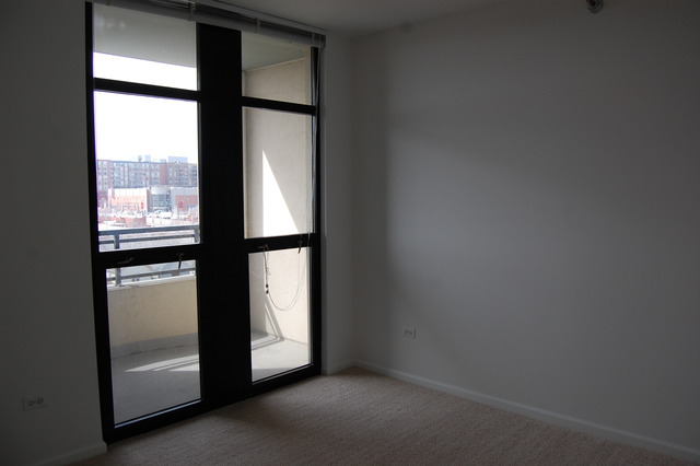 1255 South State Street, Unit 704 Chicago, IL 60605 - Photo 12 of 14 a view of an empty room with a window