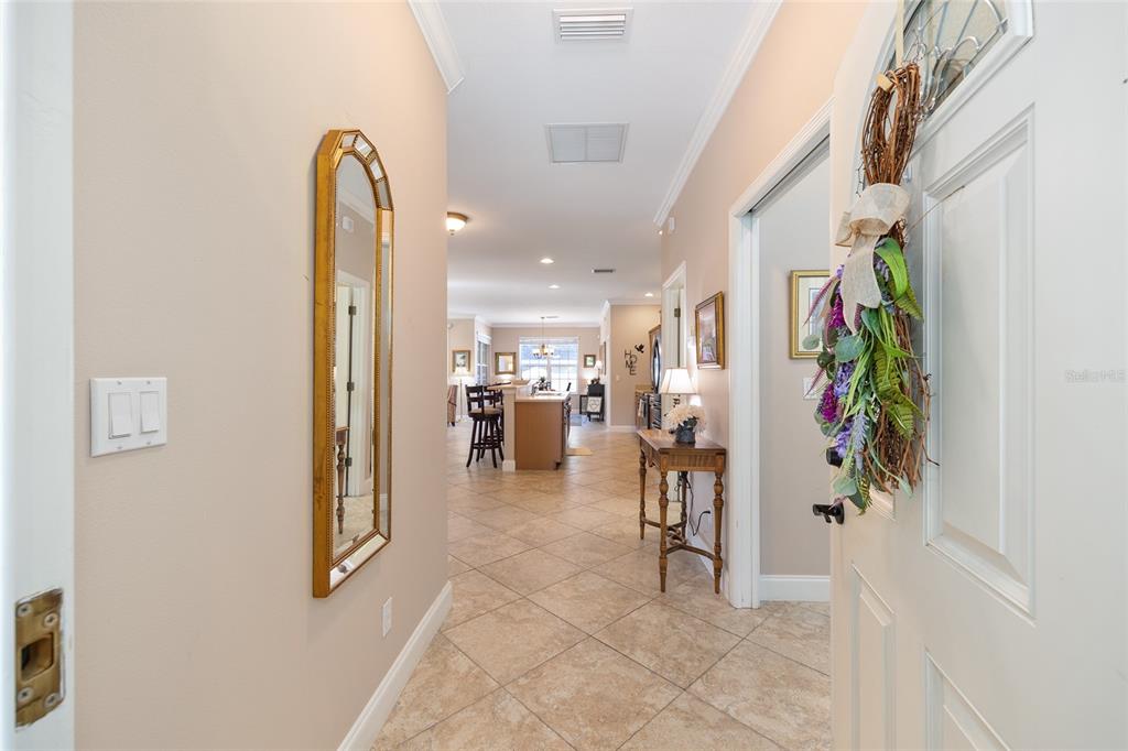3304 Southwest 38th Street Ocala, FL 34474 - Photo 7 of 21 a view of a hallway with dining area and chandelier