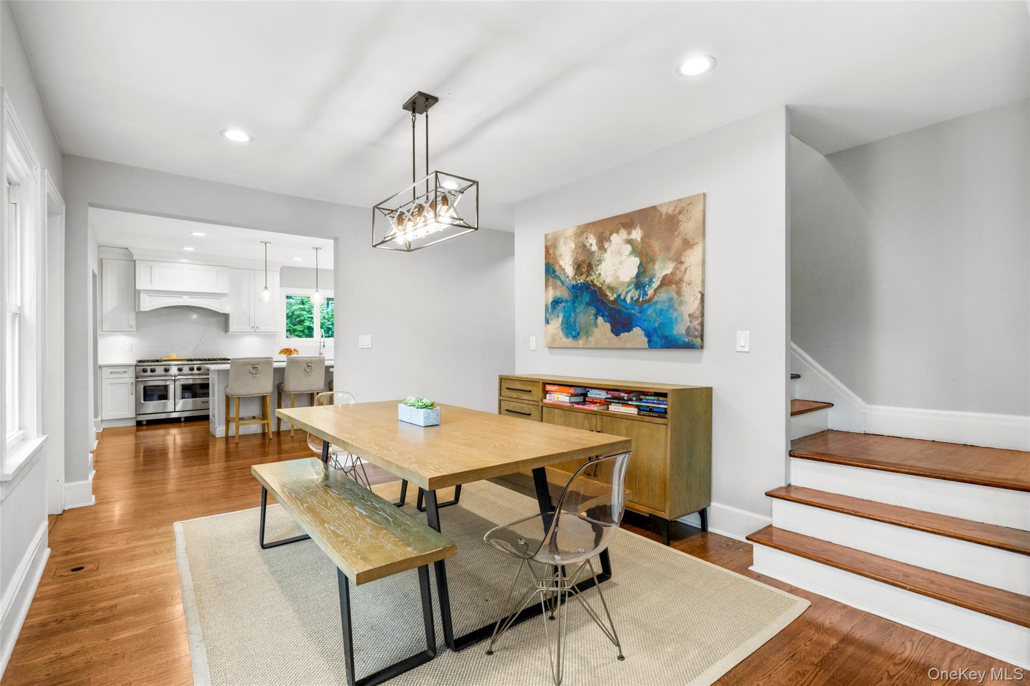 20 Elk Avenue New Rochelle, NY 10804 - Photo 12 of 40 a dining room with wooden floor a chandelier a wooden table and chairs