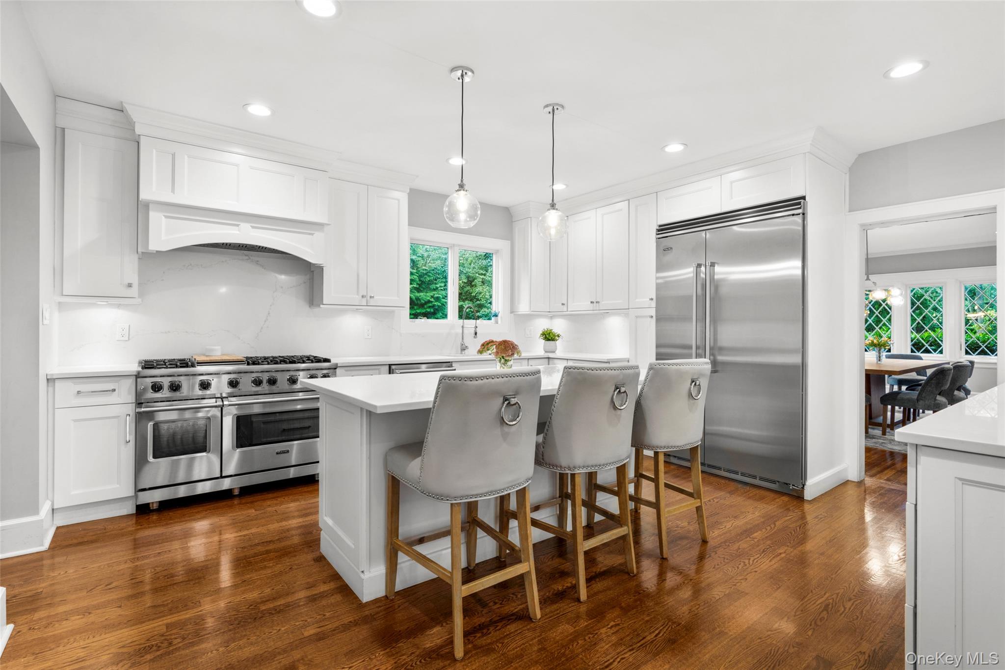 20 Elk Avenue New Rochelle, NY 10804 - Photo 14 of 40 a kitchen with stainless steel appliances a table chairs stove and wooden floor