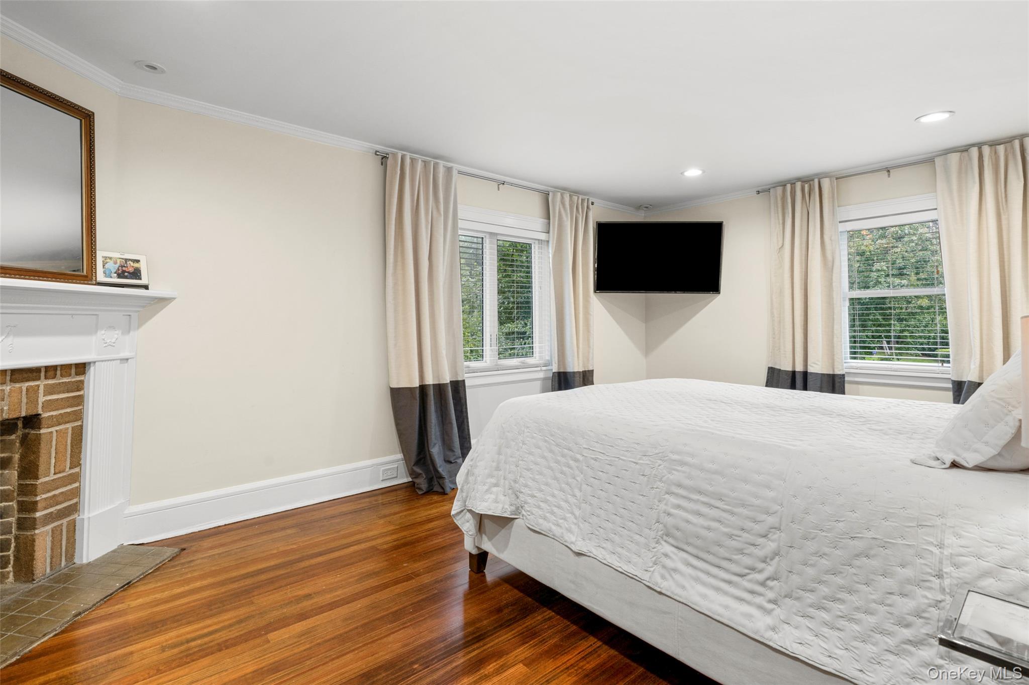 20 Elk Avenue New Rochelle, NY 10804 - Photo 25 of 40 a bedroom with a large bed and a flat screen tv
