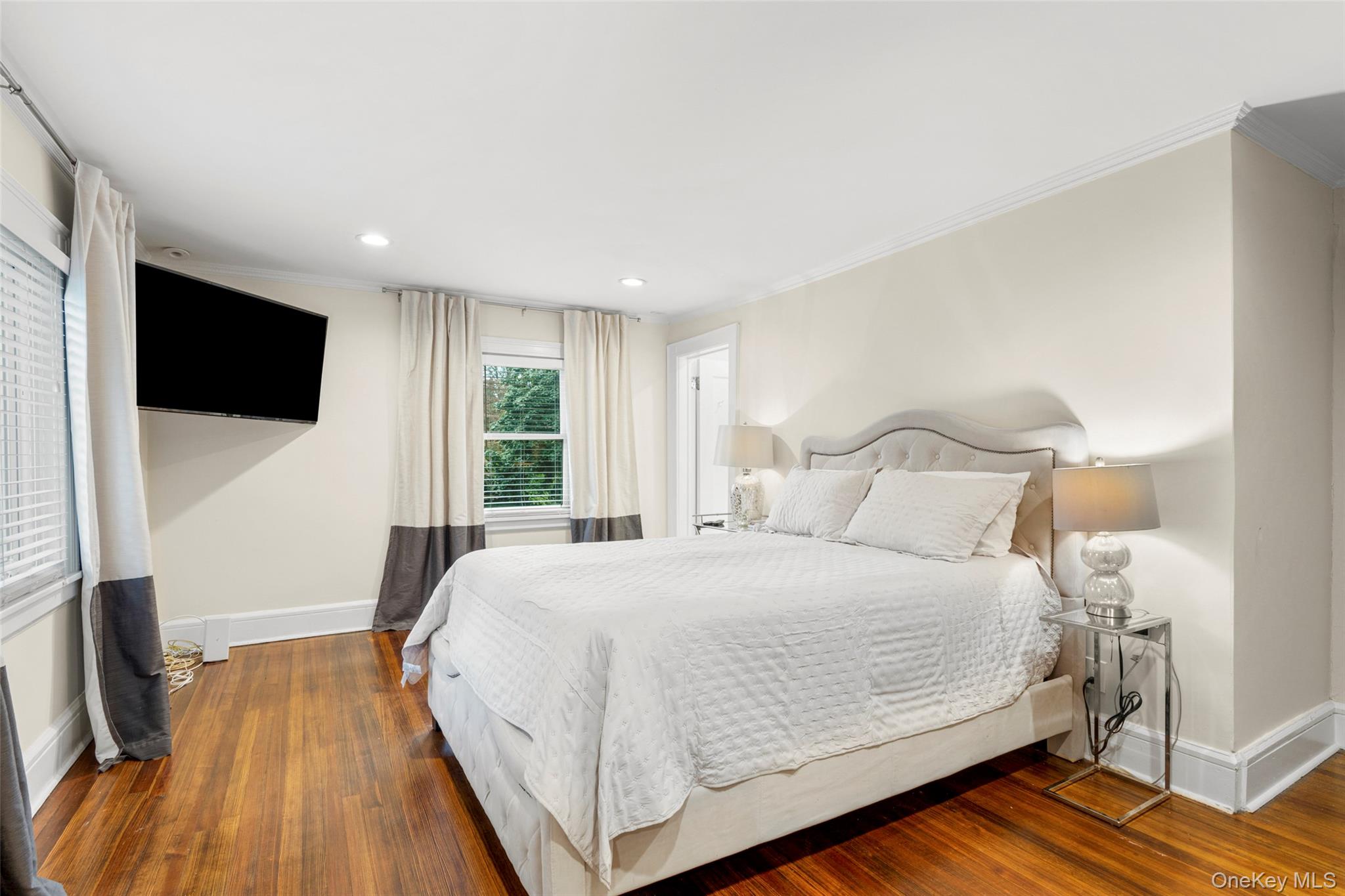 20 Elk Avenue New Rochelle, NY 10804 - Photo 26 of 40 a bedroom with a bed and a flat screen tv