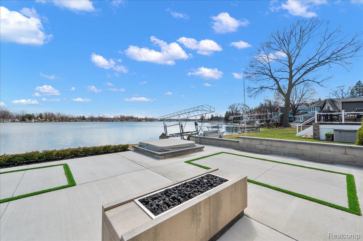 13459 Haddon Street Fenton, MI 48430 - Photo 65 of 84 View of patio featuring an outdoor fire pit, a floating dock, a water view, and boat lift