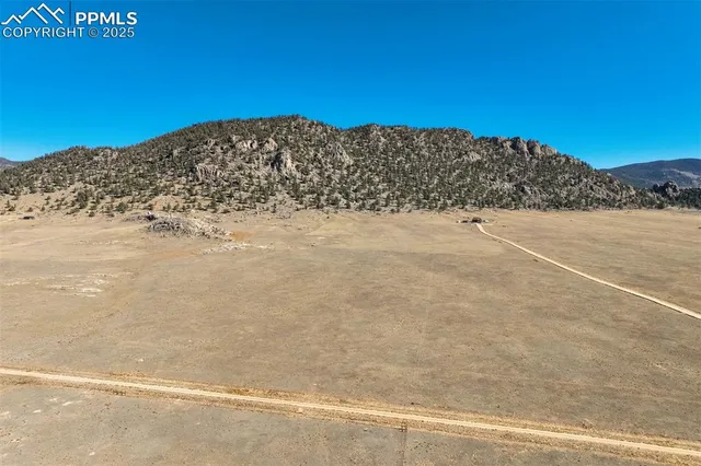 a view of a field with an ocean view