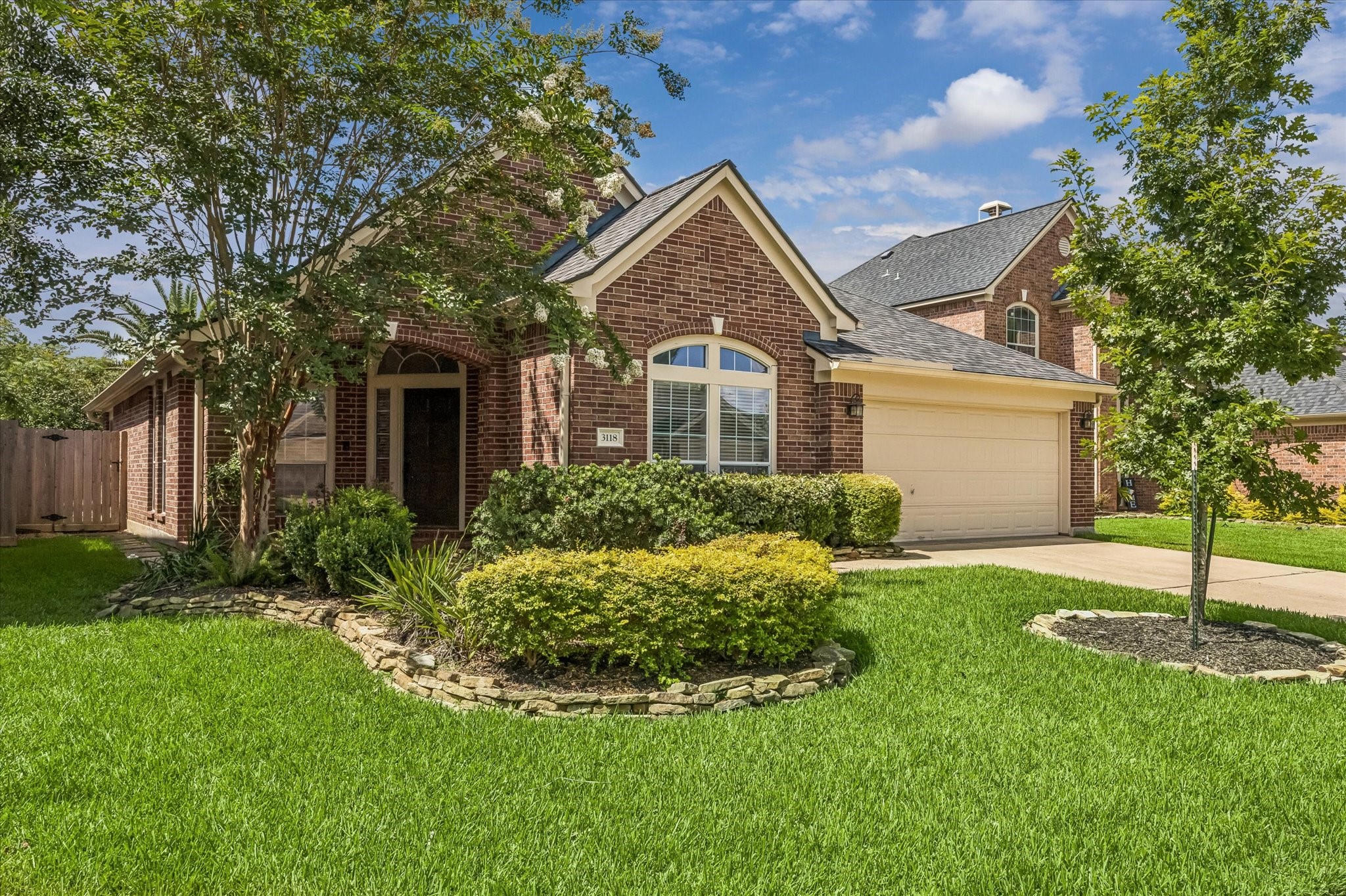 3118 Valley Court Manvel, TX 77578 - Photo 31 of 38 Charming brick home with a welcoming front yard, manicured landscaping, and mature trees. Features a two-car garage and a cozy entrance. Ideal for a potential homeowner seeking a blend of style and comfort.