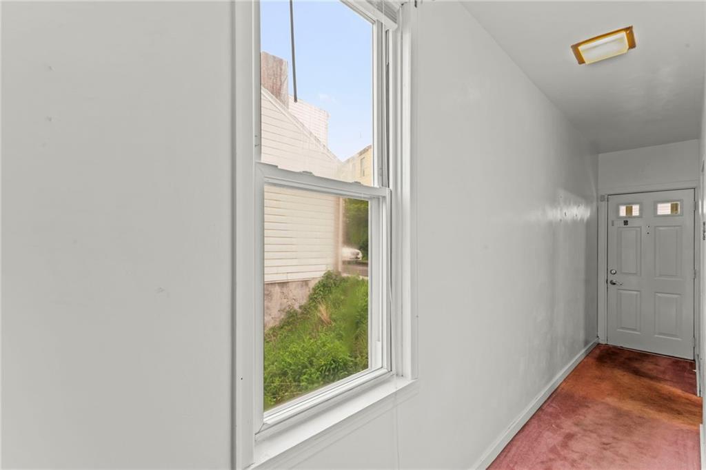 1908 St Paul Street Pittsburgh, PA 15203 - Photo 13 of 28 an empty room with wooden floor and windows
