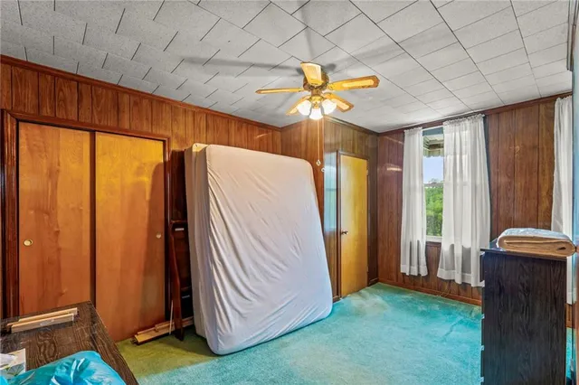 a view of a room with window and a ceiling fan