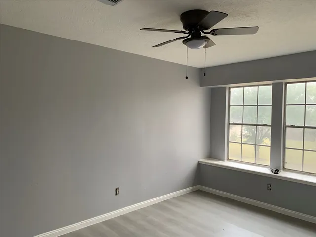 a room with window and a ceiling fan