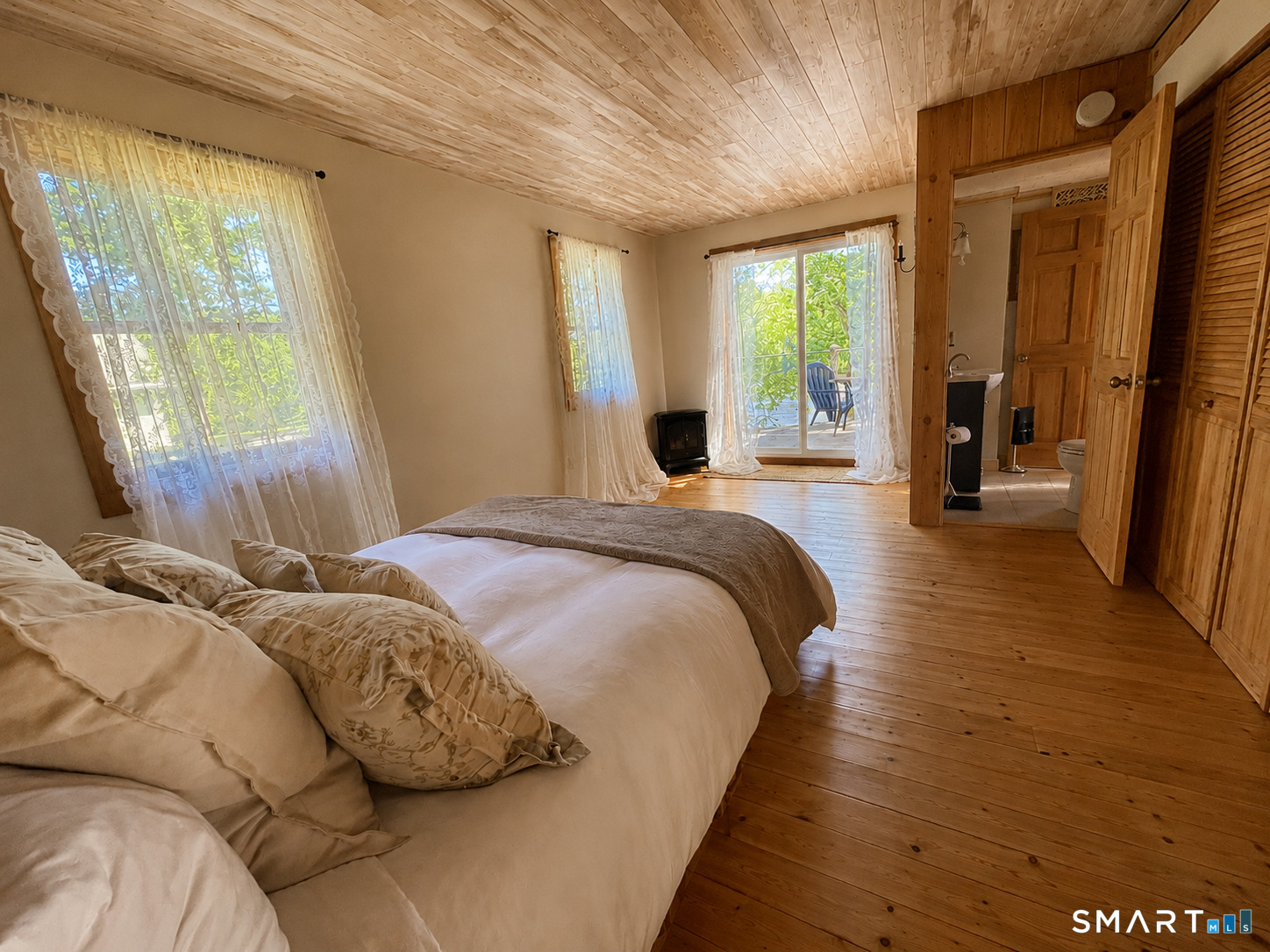 74 Cove Road, Unit 17 Haddam, CT 06424 - Photo 7 of 39 a bedroom with a bed and large windows