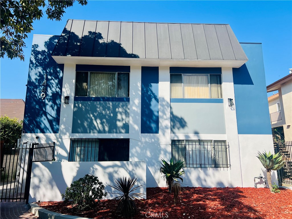 1449 South Point View Street Los Angeles, CA 90035 - Photo 4 of 11 a front view of a house with a garden