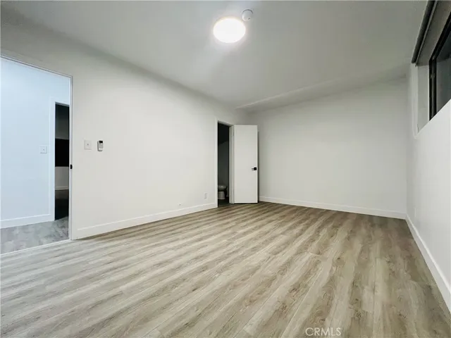 a view of an empty room and wooden floor