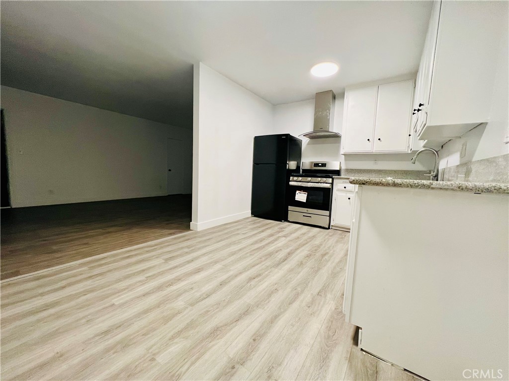 1449 South Point View Street Los Angeles, CA 90035 - Photo 7 of 11 a kitchen with granite countertop a refrigerator stove top oven and sink