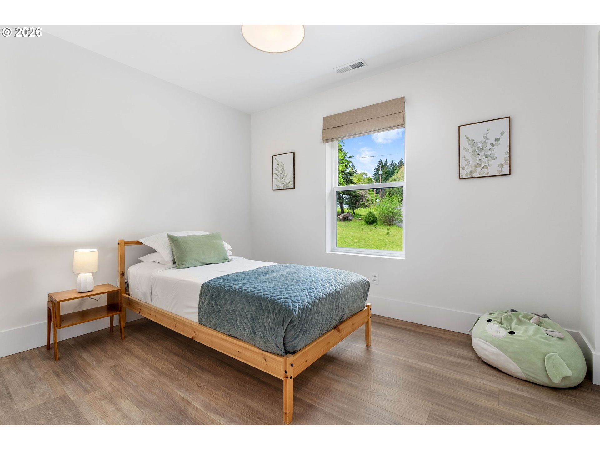 361 Frank Johns Road Stevenson, WA 98648 - Photo 10 of 27 a bedroom with a bed and wooden floor